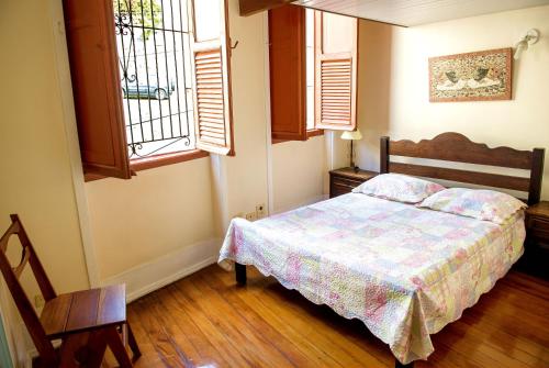 a bedroom with a bed and a window at Historic House in Rio de Janeiro