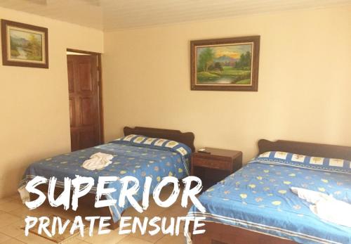 a bedroom with two beds in a room at Hotel La Choza Inn in Fortuna