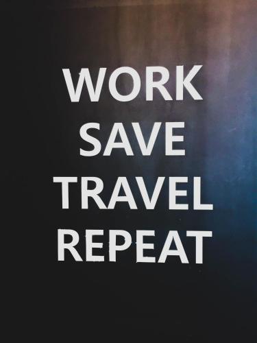 a sign that says work save travel repeat at Hotel MIDO Myeongdong in Seoul