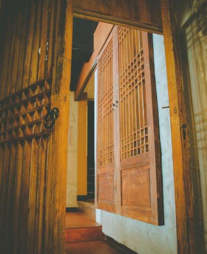an open wooden door in a room with at Hotel MIDO Myeongdong in Seoul
