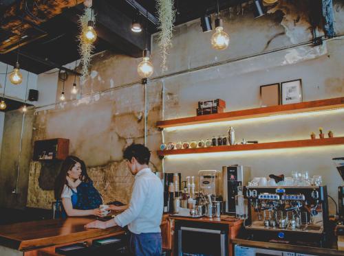a man and a woman standing at a bar at Hotel MIDO Myeongdong in Seoul