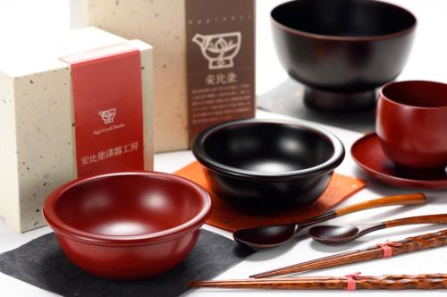 a group of bowls and spoons on a table at Hachimantai Mountain Hotel & Spa in Hachimantai