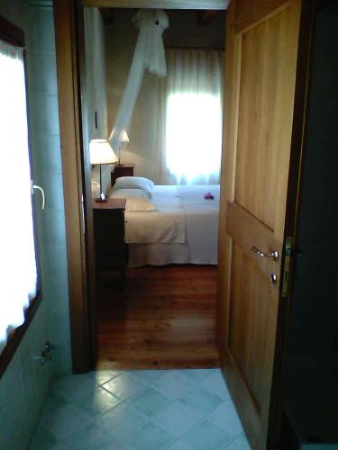 a room with a bedroom with a bed and a window at Il Rifugio del Poeta in San Biagio di Callalta