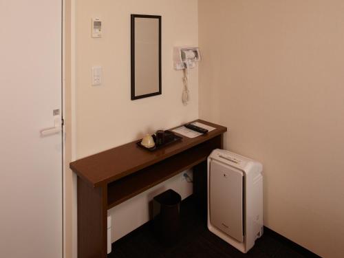 a bathroom with a wooden desk and a mirror at Osaka Academia in Osaka