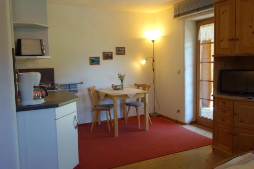 a kitchen with a table and a small table with chairs at Ferienwohnungen Bernie Schmid in Sonthofen