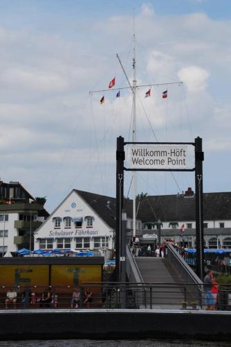 a welcome sign with flags on top of a building at Hotel Diamant in Wedel
