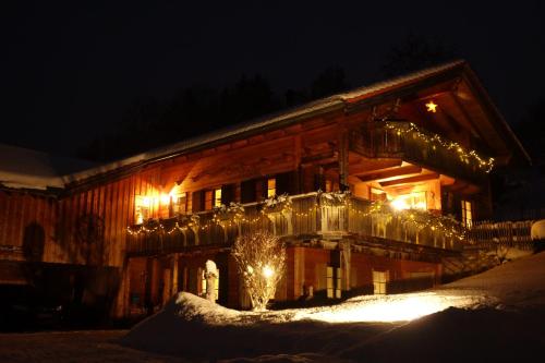 a building with christmas lights on it at night at Ferienwohnungen Bernie Schmid in Sonthofen