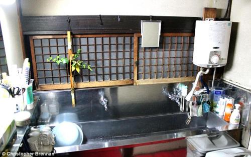 a kitchen with a sink and a counter top at Tama Ryokan in Tokyo