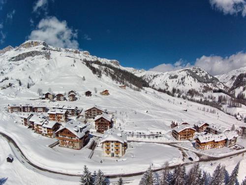 a ski lodge in the snow on a mountain at Appartamenti Home Service in Arabba