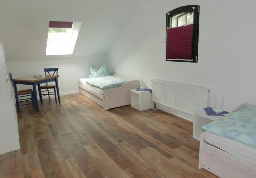 a bedroom with a bed and a table and a tableablish at Beekenhof in Bommelsen