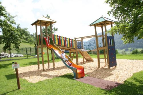 a playground with a slide in a park at Landgasthof Hotel Zehenthof in Pfarrwerfen