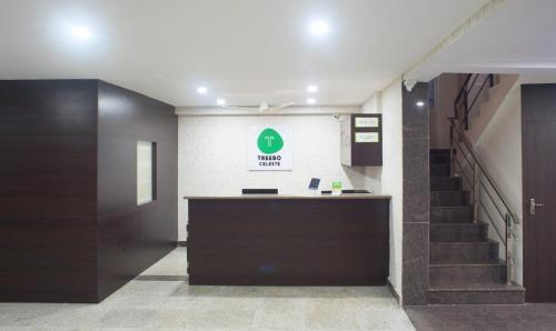 a lobby with a staircase and a reception desk at Treebo Trend Celeste in Visakhapatnam