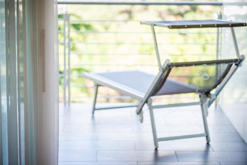 a chair sitting on top of a porch at Hotel Sonnenhof in Merano