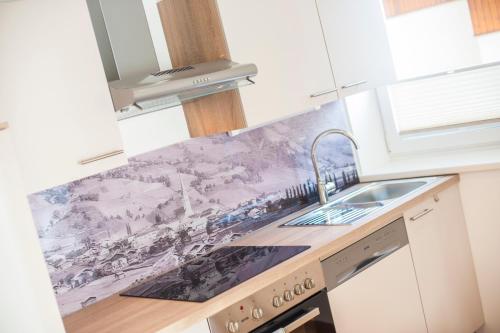 a kitchen with a marble counter top and a sink at Appartements Steiger in Bad Hofgastein
