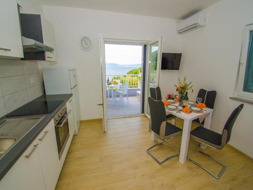 a small kitchen and dining room with a table and chairs at Apartments Vesela in Janjina