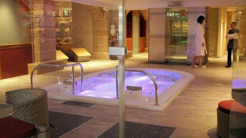 a jacuzzi tub in a store with people standing around at Mercure Moulins Centre Hôtel de Paris in Moulins