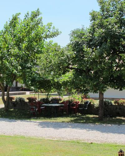 a park with tables and chairs under two trees at Ca Florian in Zero Branco