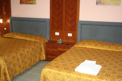a hotel room with two beds in a room at Al Seminario in Tivoli