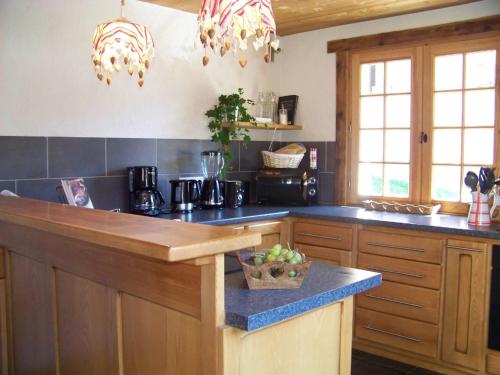 a kitchen with a counter with a blue counter top at Chalet Odette in Morzine