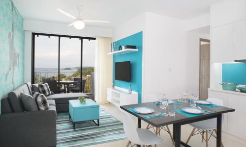 a living room with a dining table and a couch at Cassia Bintan, part of Banyan Group in Lagoi