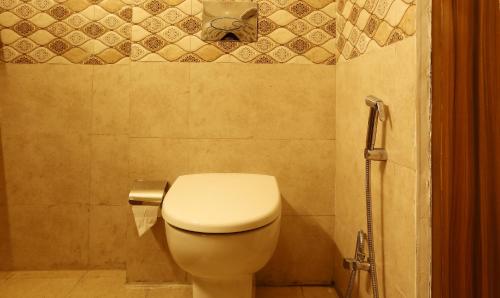 a bathroom with a toilet and a shower at Treebo Blessing Bells in Dehradun
