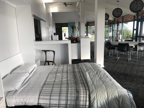a bedroom with a large bed and a dining room at Rataview in Barrytown