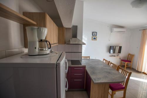 a kitchen with a coffee maker on top of a counter at Apartmani Šimić in Starigrad