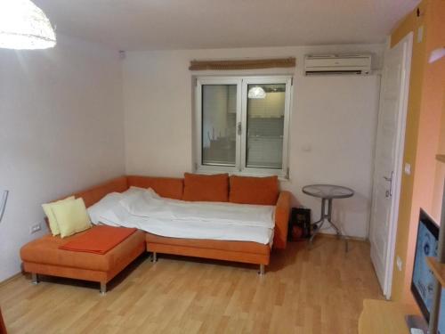 a bedroom with a bed and a chair and a window at Apartment Štinjan Kaščuni in Pula