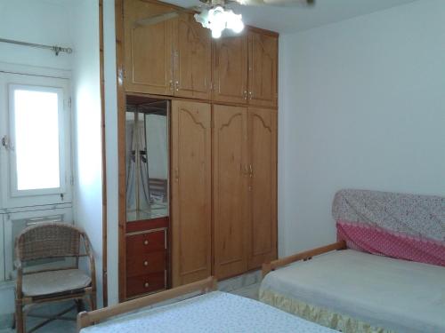 a bedroom with a bed and a dresser and a mirror at El Manal 1 Private Apartment in Ain Sokhna