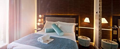Säng eller sängar i ett rum på Hotel Hostal Cuba