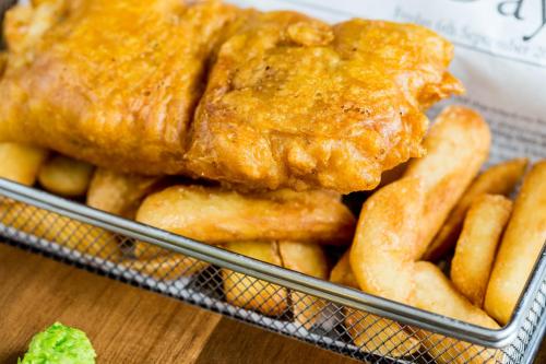 a basket of food with fried chicken and french fries at Park Plaza London, Park Royal in London