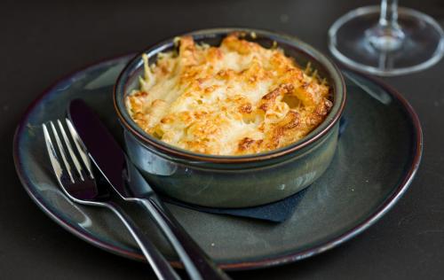 a bowl of food on a plate with a fork and knife at Park Plaza London, Park Royal in London