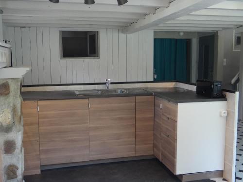 a kitchen with a sink and a counter top at Le Moulin de l'Abbé in Sorèze