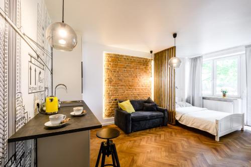 a room with a bed and a desk with a chair at Central Station Apartments in Warsaw