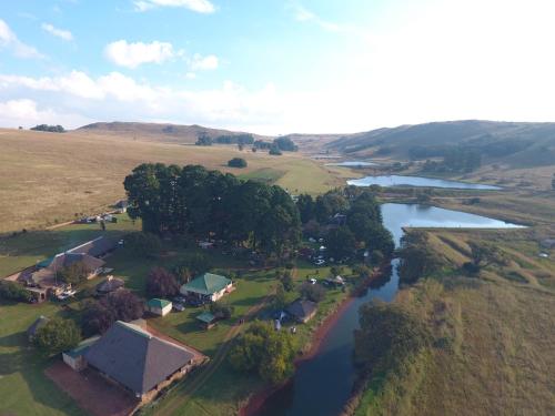 an aerial view of a small village next to a river at Elandskloof Trout Farm in Dullstroom
