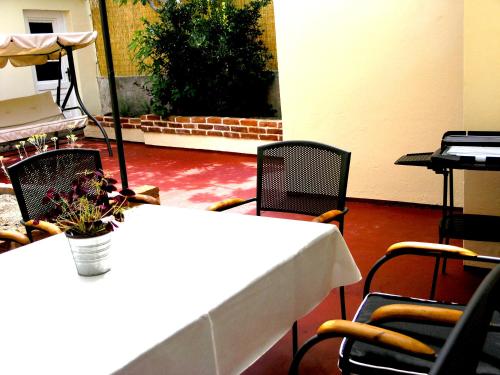 a table and chairs with a vase of flowers on it at Holiday Home Lija Center in Rab