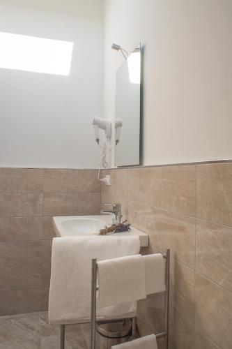 a bathroom with a sink and a mirror at Hotel Torino Porta Susa in Turin