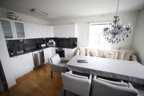 a kitchen and dining room with a table and chairs at BraMy Apartments The Bucks Villa in Tromsø