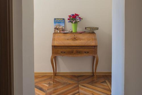 a table with a vase of flowers on top of it at Hotel Torino Porta Susa in Turin