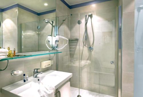 a bathroom with a shower and a sink at Hotel Nautico in Riccione