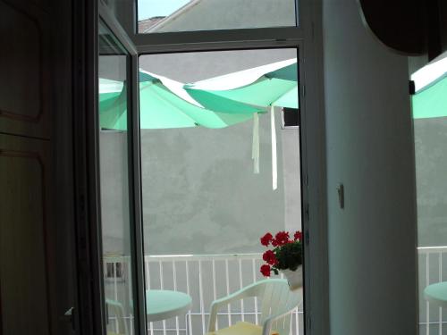 a view of a balcony with a table and an umbrella at Apart Hévízi Ház in Hévíz