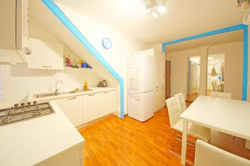 a kitchen with white cabinets and a blue stripe on the ceiling at DolceVita Apartments N 382 in Venice