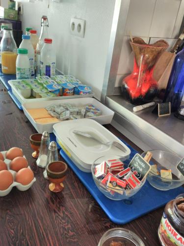 a counter with eggs and other ingredients on a table at Le Nouveau Monde in Breuillet