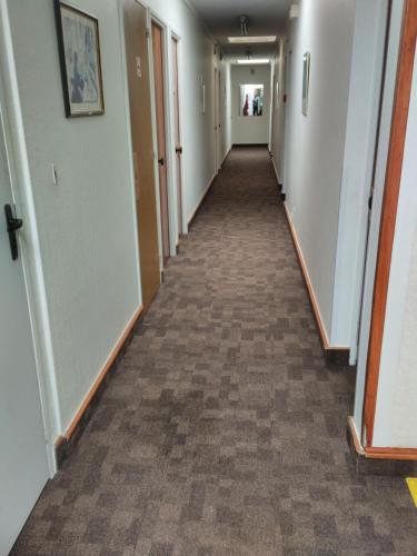 a hallway of an office building with a long corridor at Le Nouveau Monde in Breuillet
