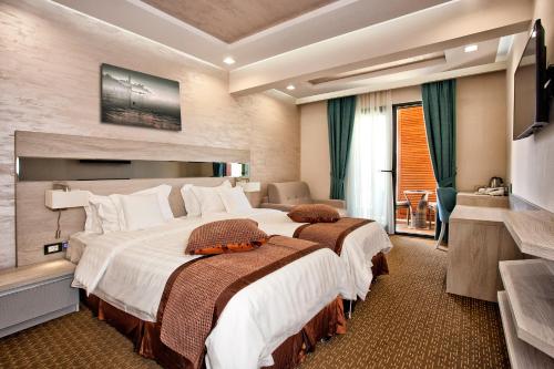 a hotel room with two beds and a television at Wellness & Spa Hotel ACD in Herceg-Novi