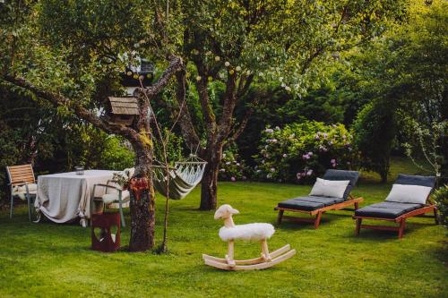 a toy sheep sitting on a sled in a yard at House Raduha - depandansa in Luče