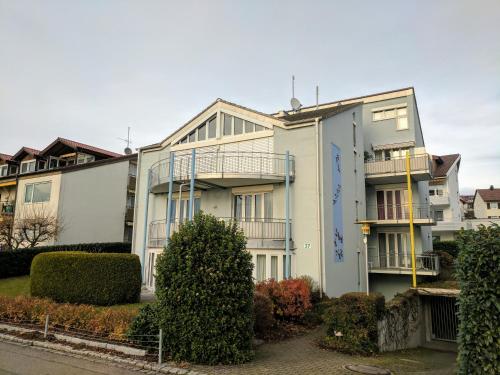 a white building with balconies on the side of it at Ferienwohnung im Atelierhaus in Meersburg