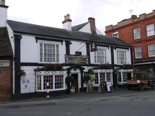 a black and white building on the corner of a street at The Bell Hotel in Winslow