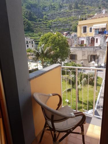 a chair and a table in a room at Hotel San Pietro in Maiori