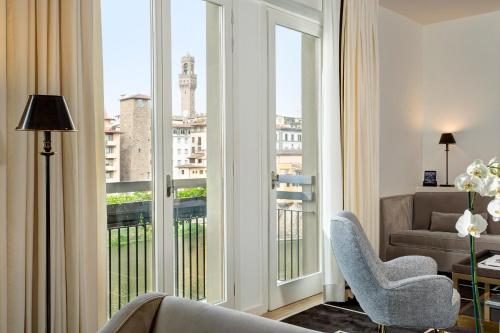 a living room with a view of a city at Hotel Lungarno - Lungarno Collection in Florence